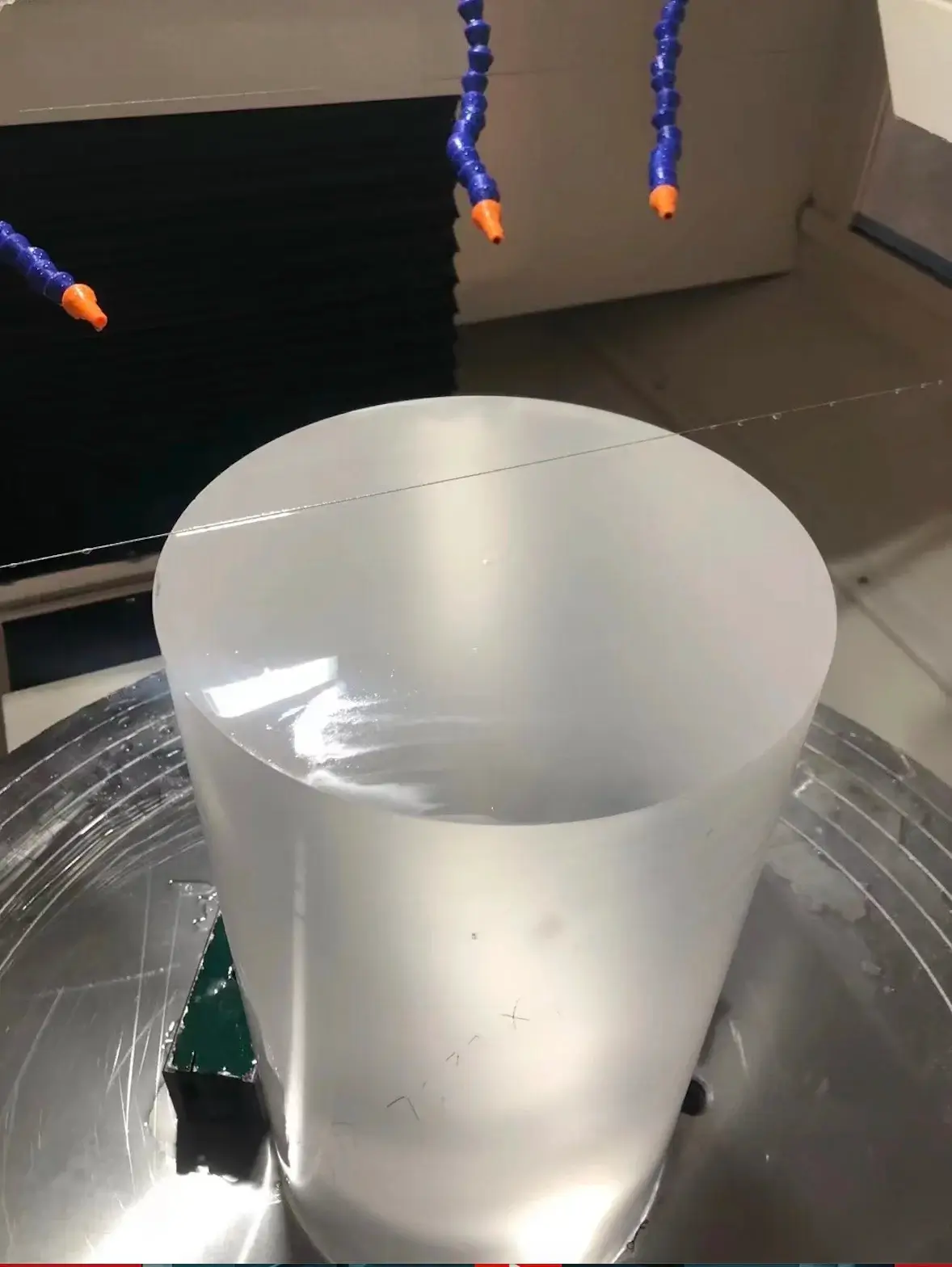 Quartz glass cylinder rotary cutting in progress on wire saw machine